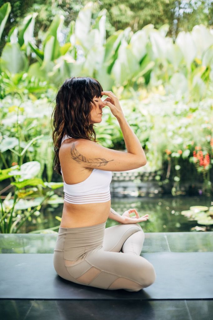 Figure in open standing posture with soft tropical colour tones